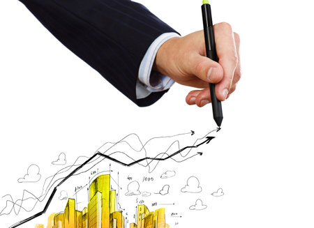 Close up of businessman hand drawing sketches of buildingsの写真素材