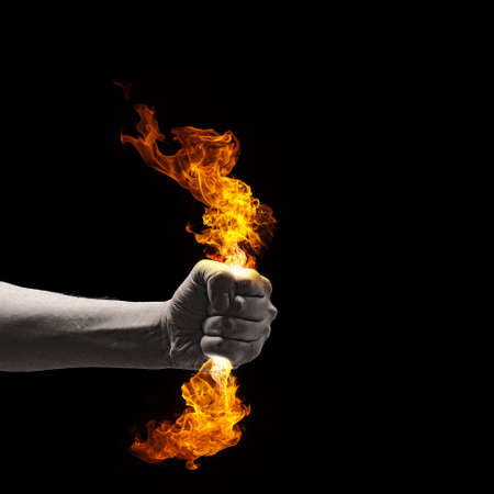 Close up of human hand holding fire flameの写真素材