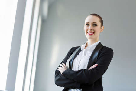 Image of young attractive businesswoman in business suit smilingの写真素材
