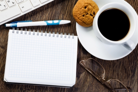 Business work place with cup of coffee calculator and glassesの写真素材