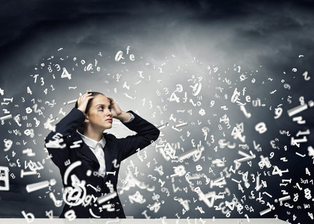 Young crying businesswoman with hands on head