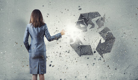 Back view of businesswoman with stone recycle symbolの写真素材