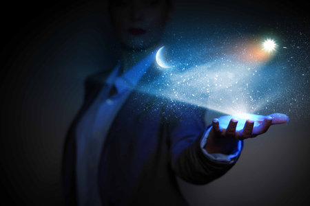 Image of businessperson holding sun and moon o palmの写真素材