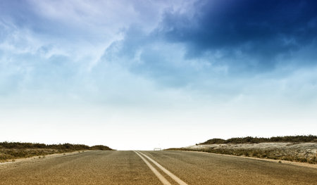 Empty suburban asphalt road with blue sky