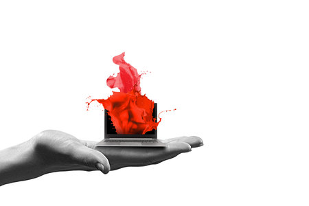 Close up of human hand holding laptop