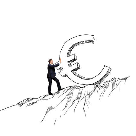 Successful businessman rolling euro sign up on hillの写真素材