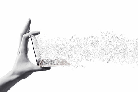 Close up of hand with laptop and media iconsの写真素材