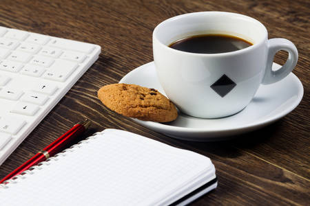 Business work place with cup of coffee calculator and glassesの写真素材