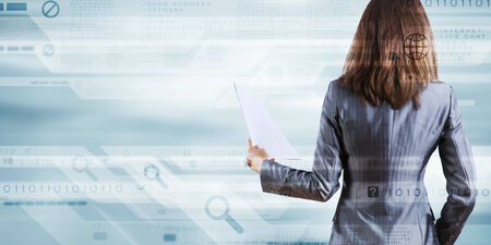 Back view of businesswoman holding papers in handsの写真素材