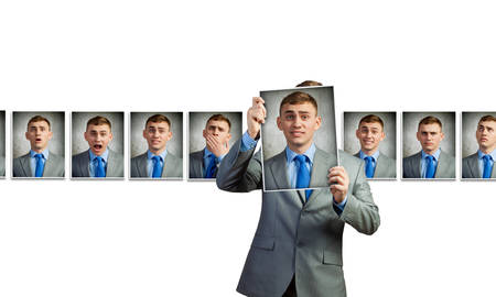 Young handsome businessman expressing different state of moodの写真素材