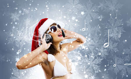Young woman in swimming suit and santa hatの写真素材