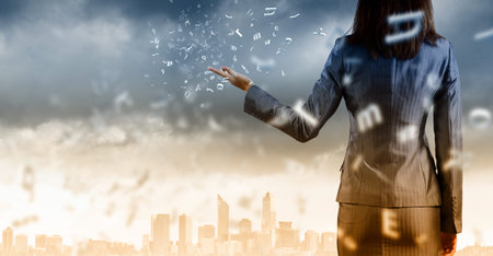 Back view of businesswoman against big city sceneの写真素材