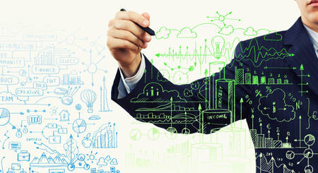 Close up of businessman drawing business sketchesの写真素材