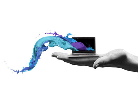 Close up of human hand holding laptopの写真素材