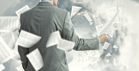 Businessman examining document in hands  Signing contractの写真素材