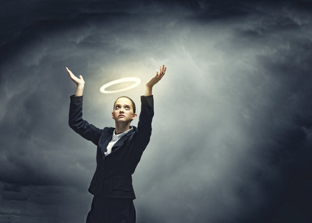 Young crying businesswoman with halo above headの写真素材