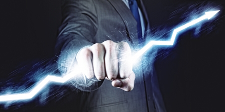 Businessman holding lightning in fist  Power and controlの写真素材