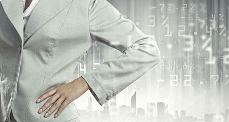 Successful businesswoman in suit against urban sceneの写真素材