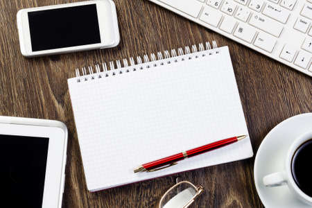 Business work place with cup of coffee calculator and glassesの写真素材