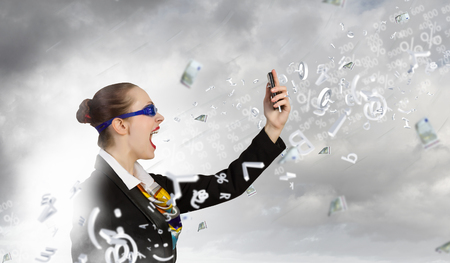 Angry businesswoman screaming aggressively in mobile phoneの写真素材