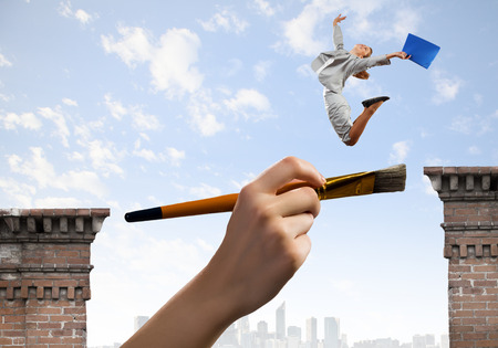 Businesswoman jumping over gap  Risk and challenge conceptの写真素材