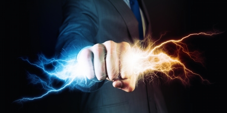 Businessman holding lightning in fist  Power and controlの写真素材