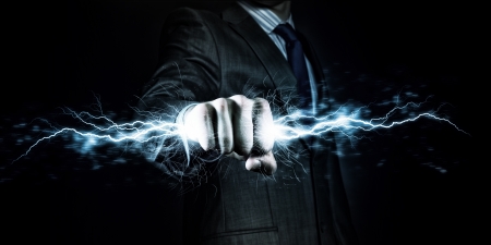 Businessman holding lightning in fist  Power and controlの写真素材