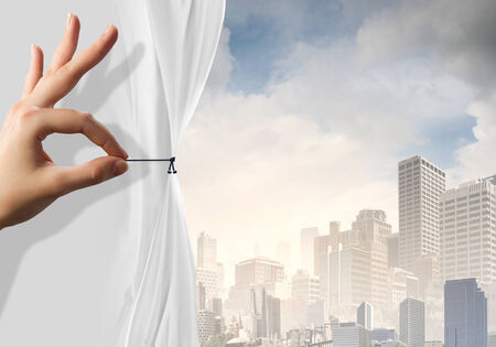 Close up of hand opening the white curtainの写真素材