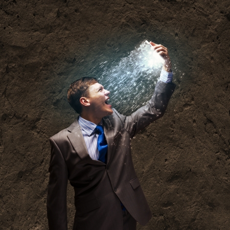 Angry businessman screaming furiously in to mobile phoneの写真素材