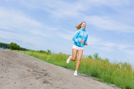 Young beautiful girl training outdoor in summerの写真素材
