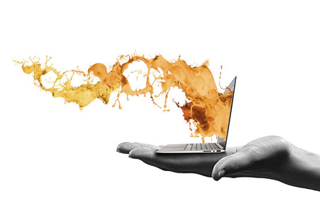 Close up of human hand holding laptop