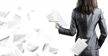Back view of businesswoman holding papers in handsの写真素材