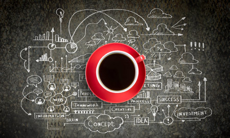 Cup of coffee with sketches at background