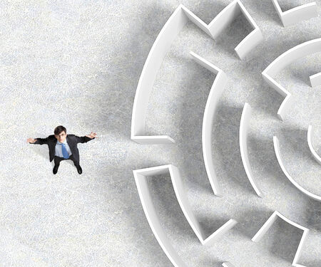 Top view of businessman standing near the enter of labyrinthの写真素材