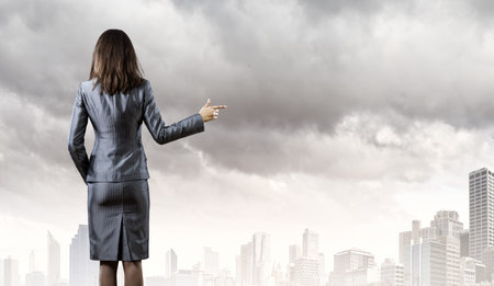 Back view of businesswoman in business suitの写真素材