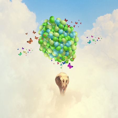 Sunny image of elephant flying in sky on aerostat