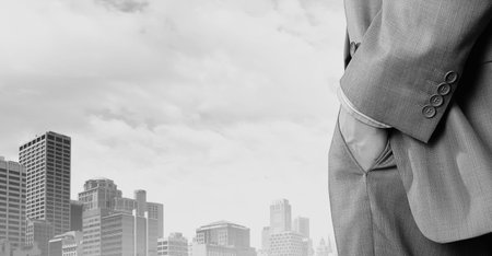 Close up of businessman standing on top viewing at cityの写真素材