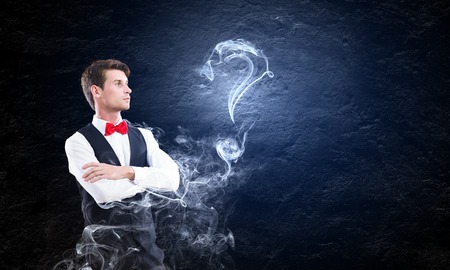 Young handsome businessman in fumes smoking pipeの写真素材