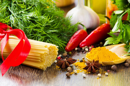 Chilli pepper macaroni herbs and splices on kitchen tableの写真素材
