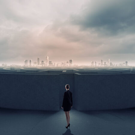 Businesswoman standing near the enter of labyrinthの写真素材