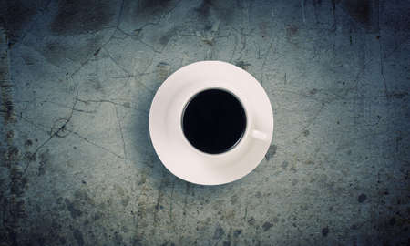 Conceptual image of cup of coffee on stone surfaceの写真素材