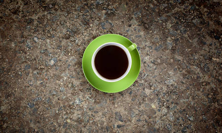 Conceptual image of cup of coffee on stone surfaceの写真素材