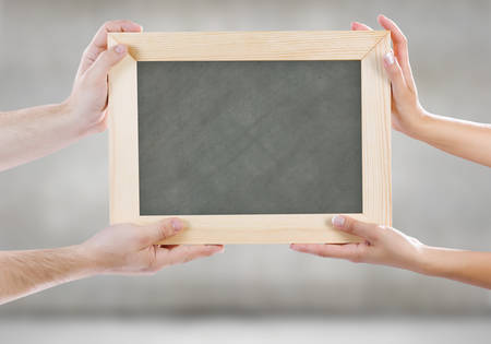 Close up of human hands holding blank frameの写真素材