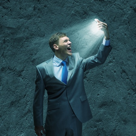 Angry businessman screaming furiously in to mobile phoneの写真素材