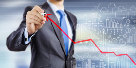 Close up of businessman drawing increasing graphの写真素材