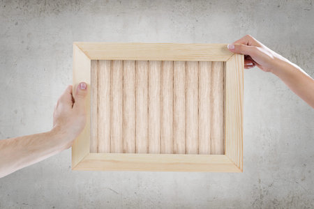 Close up of human hands holding blank frame