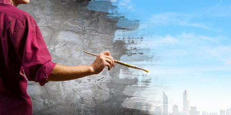 Young handsome man painter with brush in hand