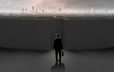 Successful businessman standing near the entrance of labyrinthの写真素材