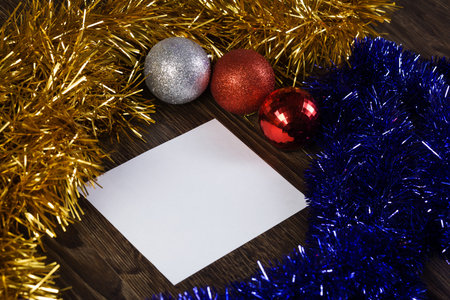 White blank card with decoration balls and tinsel  Place for text