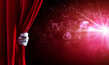 Human hand in white glove opening red velvet curtainの写真素材